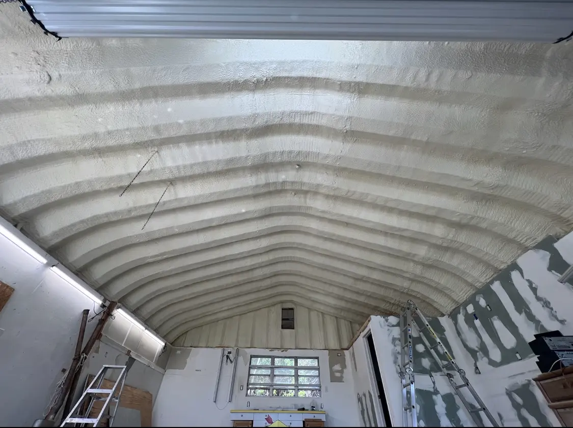 Spray polyurethane foam applied to the underside of a metal roof deck in DeKalb